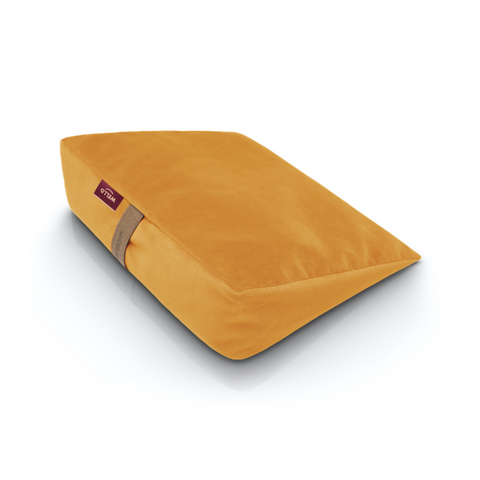 Wedge pillow for sitting in a yellow velour cover