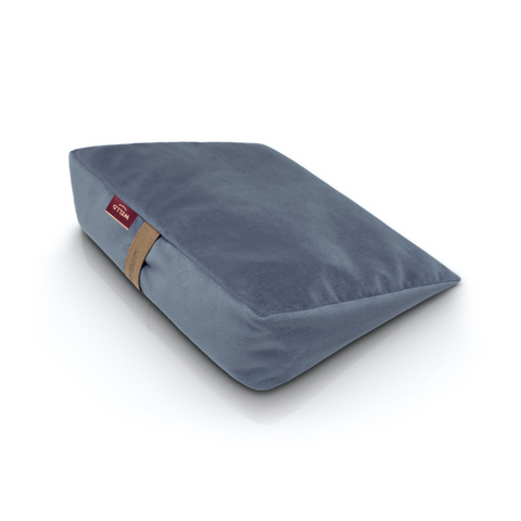 Wedge pillow for sitting in a blue velour cover