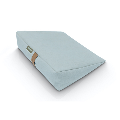 Buckwheat wedge pillow in a light gray linen and cotton cover