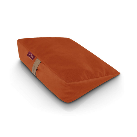 Wedge pillow for sitting in a orange velour cover