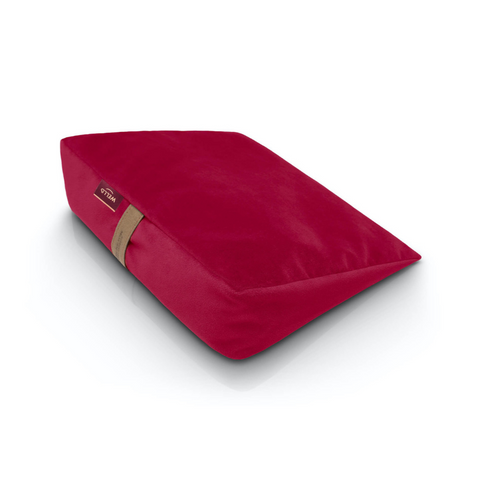 Wedge pillow for sitting in a raspberry pink velour cover