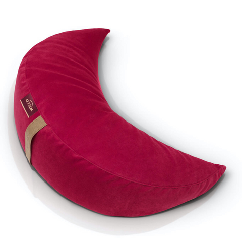 buckwheat half-moon cushion in a raspberry pink velour cover